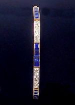 An 18 ct gold bracelet line set alternate links of brilliant cut diamonds and square cut