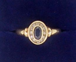 A 9 carat gold sapphire and diamond cluster ring, size L-M