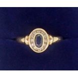 A 9 carat gold sapphire and diamond cluster ring, size L-M