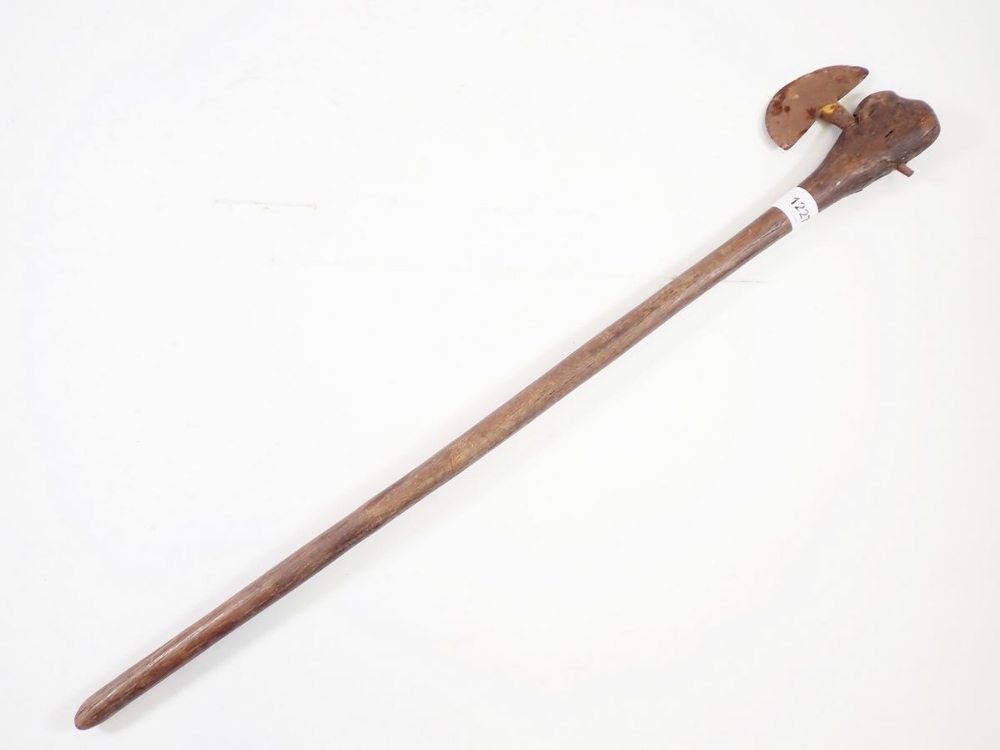 An antique tribal fighting axe with wooden handle and metal head, 67cm