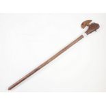 An antique tribal fighting axe with wooden handle and metal head, 67cm