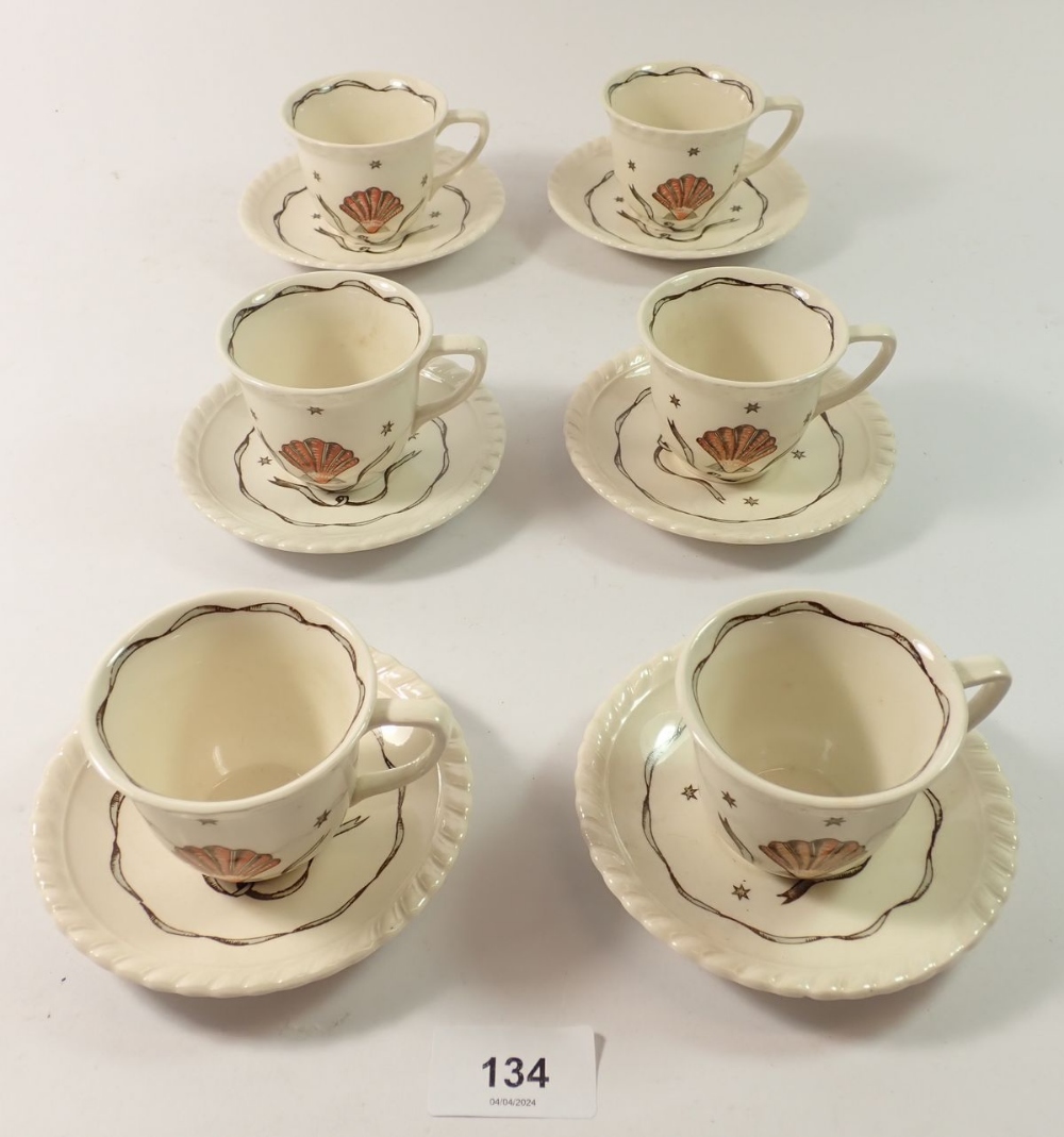 A Heals vintage set of six coffee cups and saucers painted shell motif
