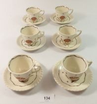 A Heals vintage set of six coffee cups and saucers painted shell motif