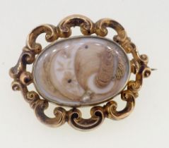 A Victorian gold mourning brooch with hair locket to front and back , unmarked but tested as gold,