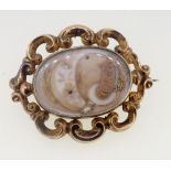 A Victorian gold mourning brooch with hair locket to front and back , unmarked but tested as gold,