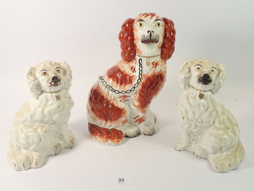 Three Victorian Staffordshire dogs, largest a/f, 19cm and 23cm