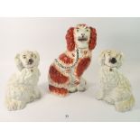 Three Victorian Staffordshire dogs, largest a/f, 19cm and 23cm