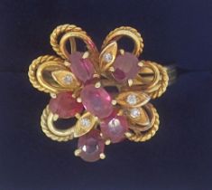 A vintage gold asymmetrical ring set six oval cut rubies and five chip diamonds, size R to S