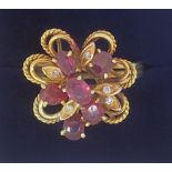 A vintage gold asymmetrical ring set six oval cut rubies and five chip diamonds, size R to S