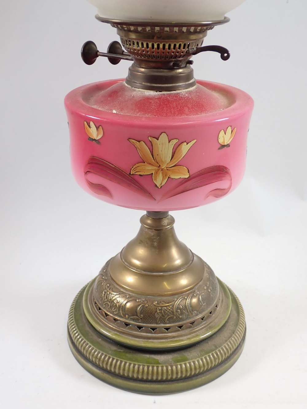 A Victorian oil lamp with pink floral painted glass reservoir, stoneware and brass base and etched - Image 2 of 2