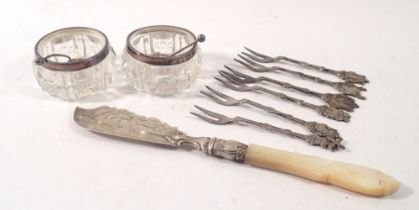 A pair of cut glass and silver rimmed salts, a Victorian silver and mother of pearl butter knife and