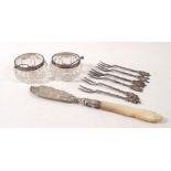 A pair of cut glass and silver rimmed salts, a Victorian silver and mother of pearl butter knife and