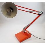 A vintage red anglepoise desk lamp