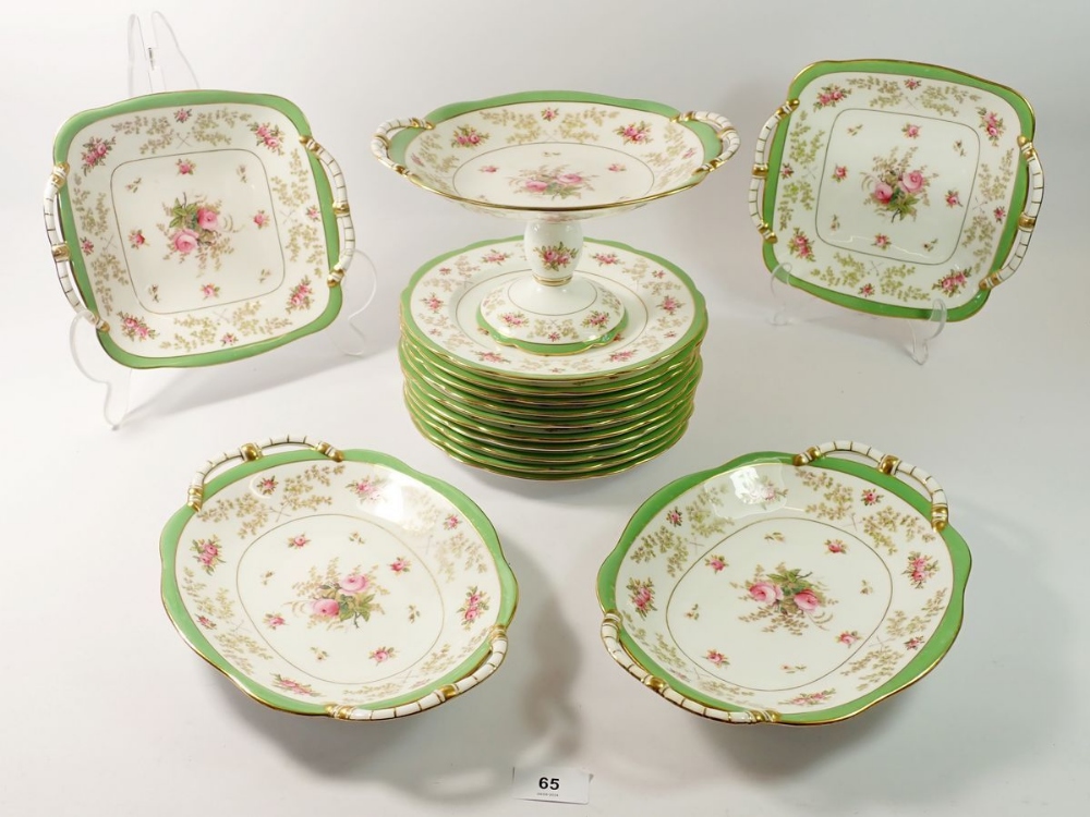 An Edwardian Coalport floral painted dessert service with green borders comprising comport, ten