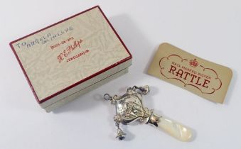 A silver hallmarked rattle with mother of pearl handle, boxed