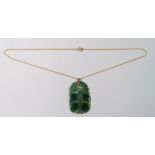 A Chinese 9 carat gold mounted jade pendant carved fruit, 4.5 x 3cm on 9 carat gold chain