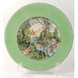 A porcelain plate painted landscape, signed John Flaxman to reverse, 24cm