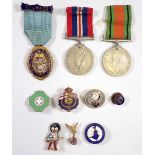 A WWII Defence Medal and War Medal plus a group of badges incluidng Junior Imperial and