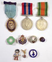 A WWII Defence Medal and War Medal plus a group of badges incluidng Junior Imperial and
