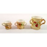 A Royal Worcester three handled miniature tyg painted flowers on an ivory blush ground and two