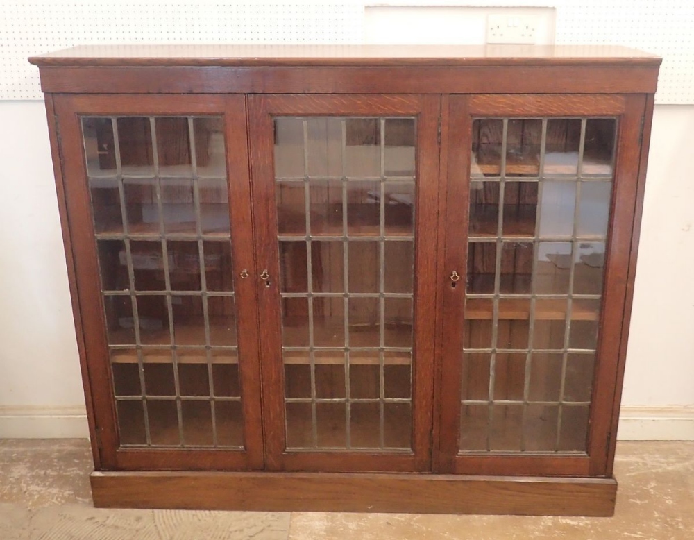 An early 20th century oak lead glazed dwarf bookcase with three doors enclosing shelves, 156cm - Image 2 of 5