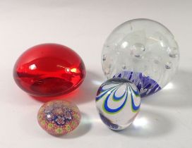 Four various glass paperweights, largest 8.5cm tall