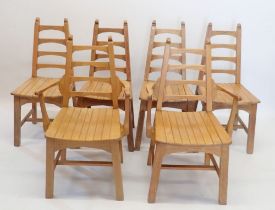 A set of six early 20th century Arts & Crafts light oak dining chairs with tapered ladder backs by