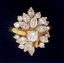 An 18 carat gold ring set asymmetrical arrangement of brilliant and marquise cut diamonds, size M to
