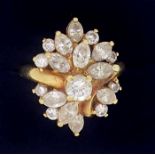 An 18 carat gold ring set asymmetrical arrangement of brilliant and marquise cut diamonds, size M to