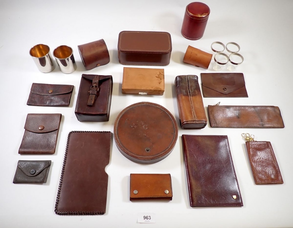 A group of small leather items incluidng cigarette and cigar cases, purse, stirrup cups etc.