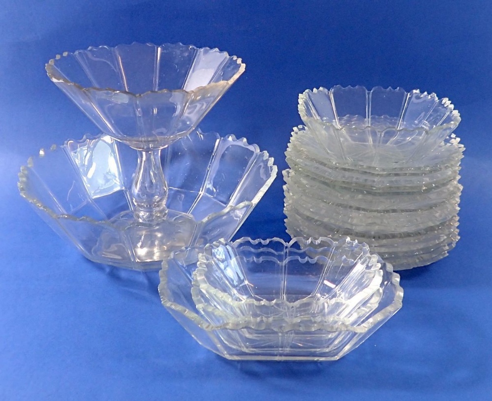 An early 19th century faceted cut glass dessert service with scalloped edges comprising comport,