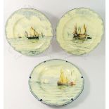 A set of three Royal Crown Derby plates painted yachts and sailing boats, 25.5cm diameter