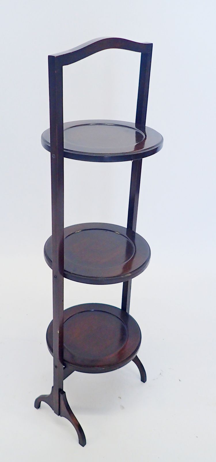 A folding three tier mahogany cake stand