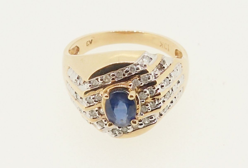 A 10k gold ring set oval cut sapphire in five diagonal rows of channel set diamonds, 5.6g, size W - Image 2 of 4