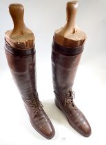 A pair of 1930's mens military brown leather field boots with wooden boot trees, approx size 10