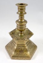 A 19th century Dutch hexagonal brass candlestick with engraved decoration, 21cm