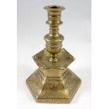 A 19th century Dutch hexagonal brass candlestick with engraved decoration, 21cm