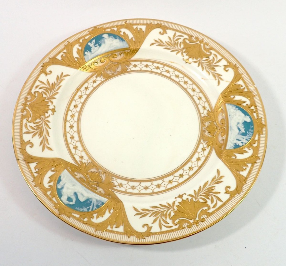 A Minton plate with three pate sur pate panels with gilt shell and leaf decoration, cracked and