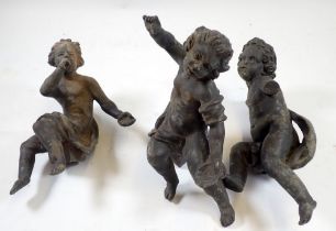 Three antique cast lead putti figures with fittings to bases, 20cm tall approx