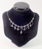 An antique long silver moonstone pendant necklace, 70cm long