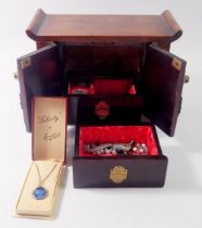 An oriental wooden jewellery box with a group of costume jewellery including silver and enamel