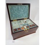 A Victorian rosewood needlework box with fitted interior including wooden reels and lift out tray,