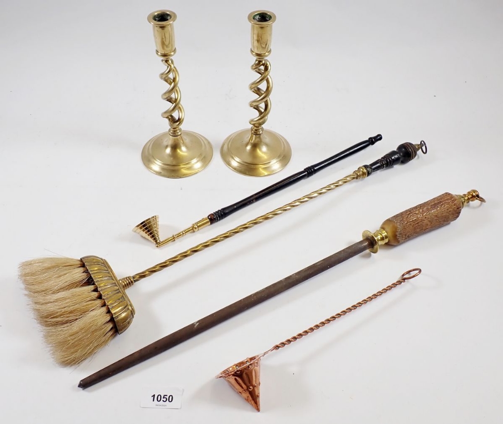 A pair of brass wrythen twist candlesticks, candle snuffer, butchers steel and hearth brush