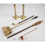 A pair of brass wrythen twist candlesticks, candle snuffer, butchers steel and hearth brush