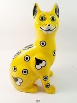 A Griselda Hill Wemyss cat decorated hearts and spots on a yellow ground, 33.5cm