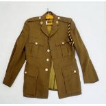 An Army officers army jacket with Royal Logistics buttons, collar badges etc. by Moss Bros