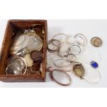 A quantity of antique watch glasses and yellow metal locket surrounds