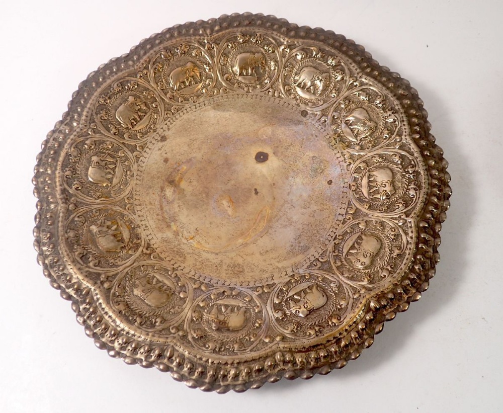 A Burmese white metal bowl with embossed foliage and deity, inscribed and dated 1926, maks to - Image 3 of 4