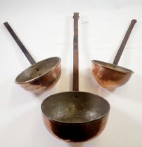 A set of three Victorian large graduated copper kitchen ladles, 66cm long