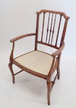 An Edwardian lightwood chair with spindle back